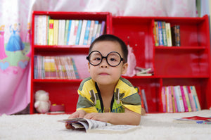 Child with Glasses and Book